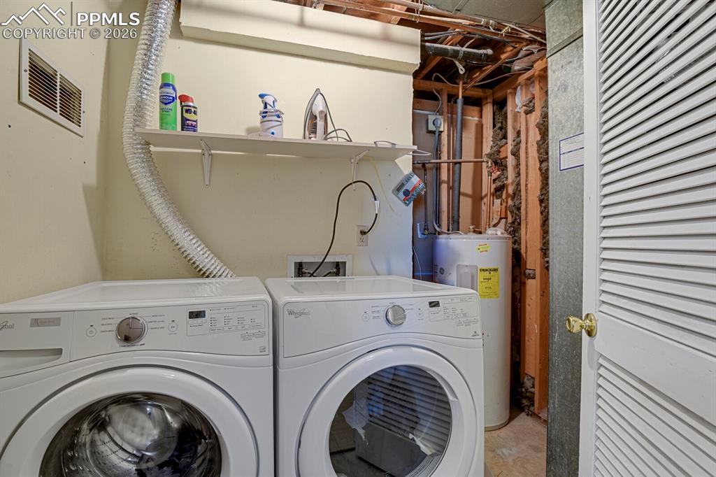 Image 21 of 30: Dedicated laundry space with a washer and dryer