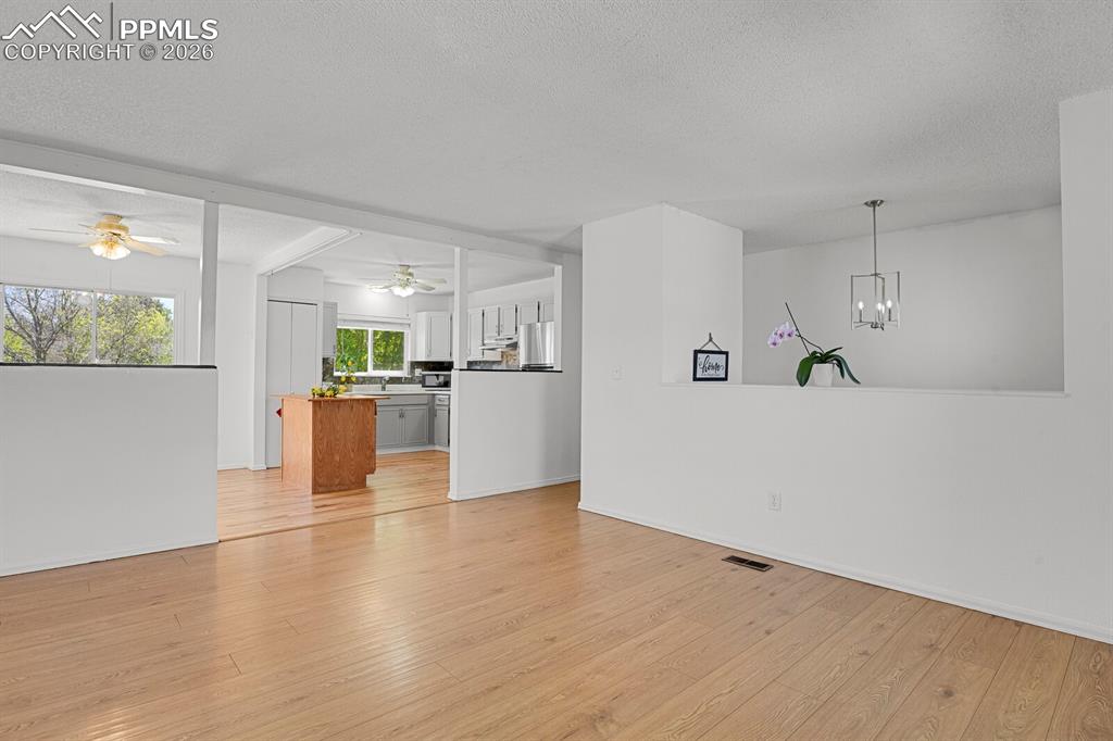 Image 3 of 30: The property features light-toned flooring, white walls, and a modern hangi