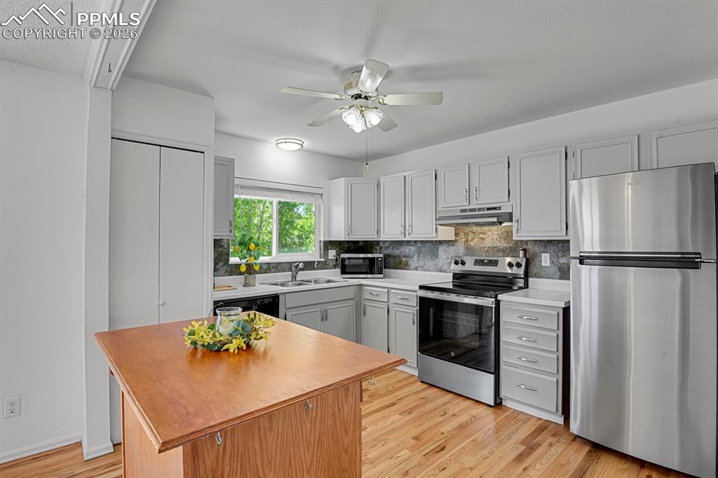 Image 6 of 30: Well-appointed kitchen featuring light-colored cabinetry, stainless steel a