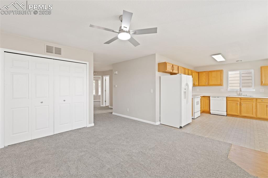 Image 17 of 50: Living room also features a main level laundry closet with included washer 
