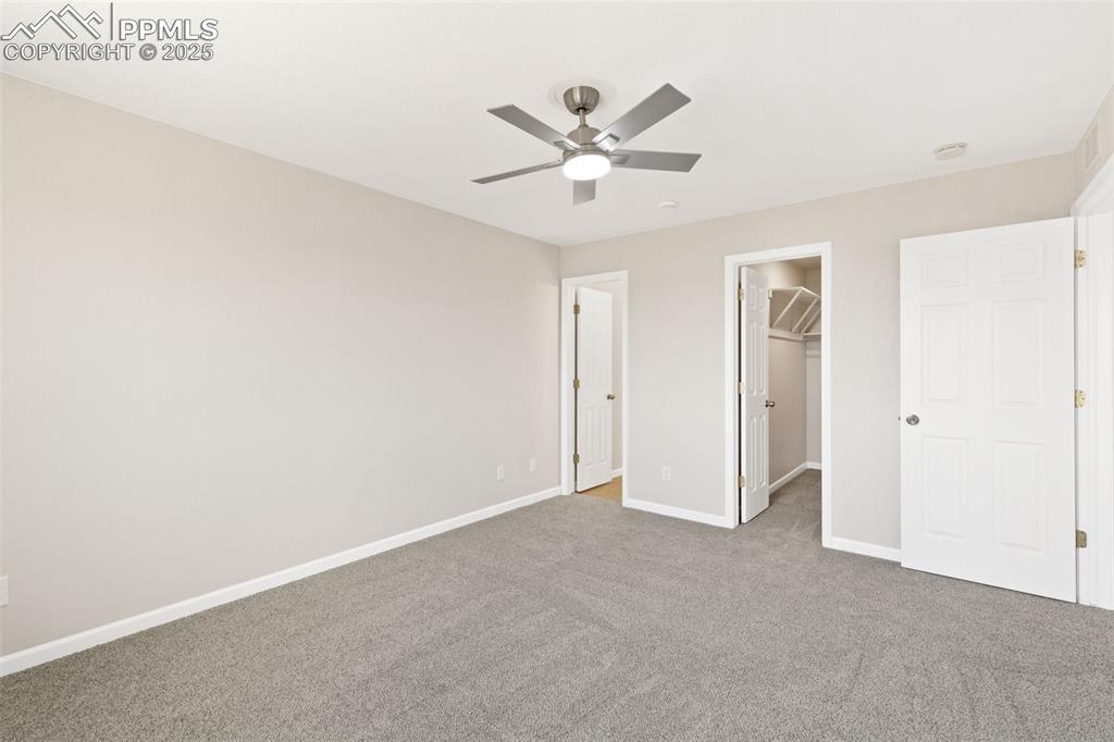 Image 34 of 50: Primary bedroom also offers a ceiling fan for temperature regulation
