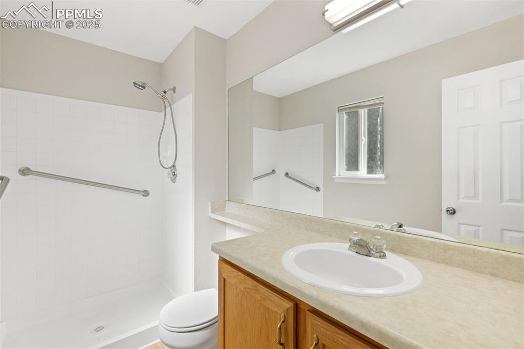 Image 37 of 50: Primary bathroom with a walk-in shower and large vanity