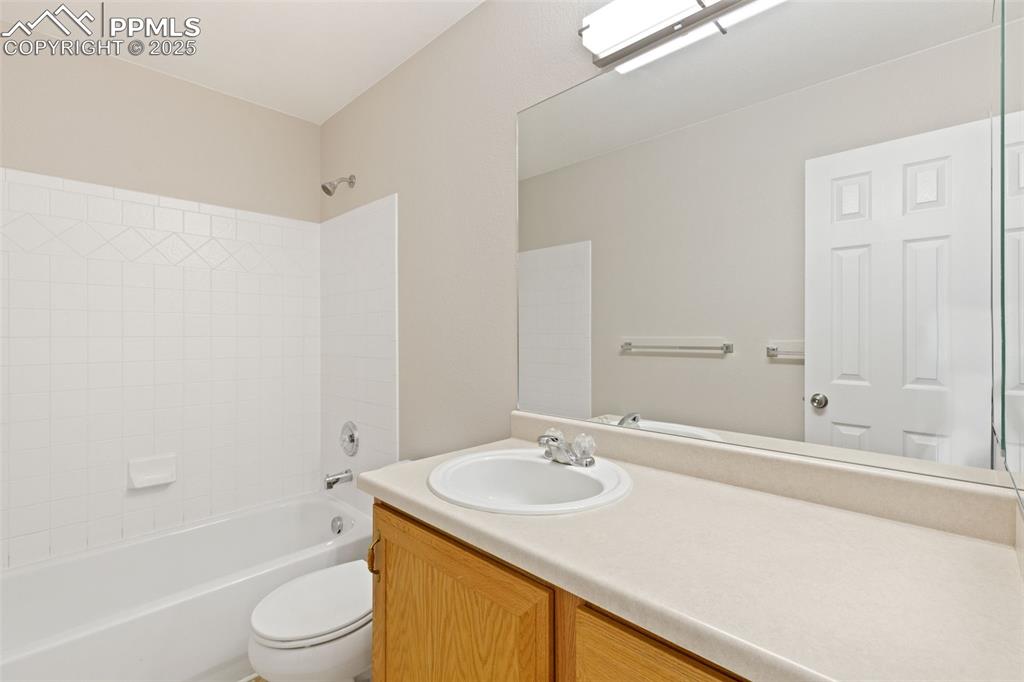 Image 6 of 50: Full bathroom with large vanity top and white tile shower surround
