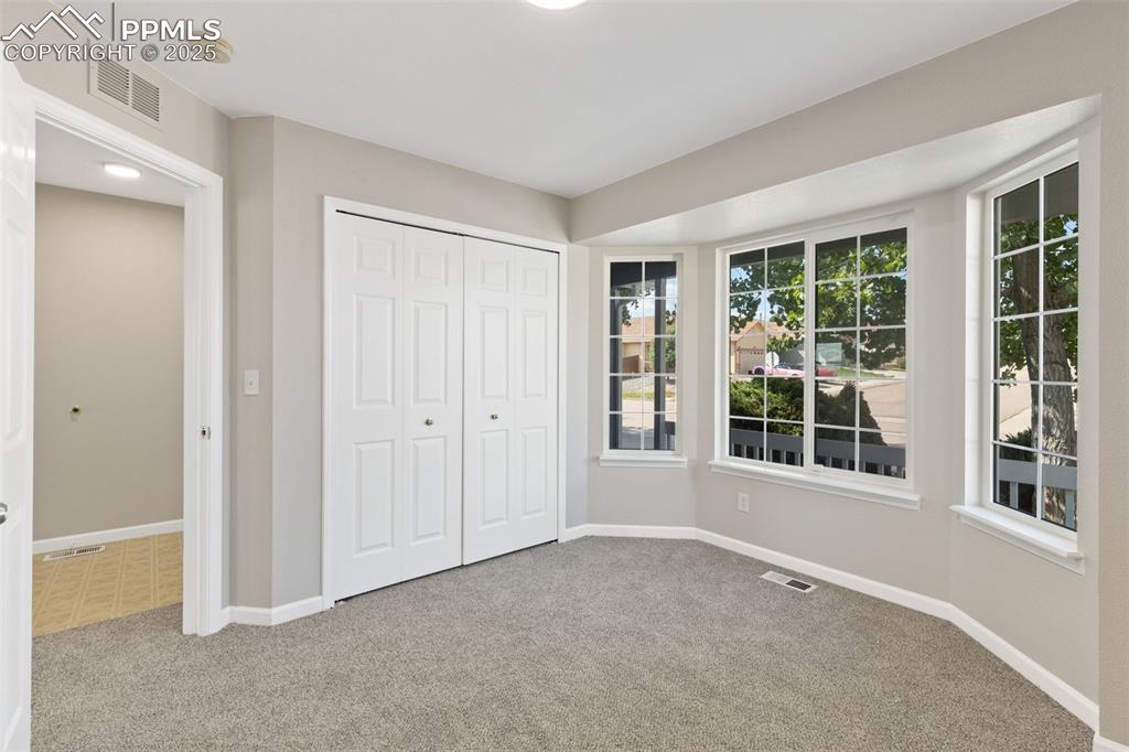 Image 9 of 50: The front bedroom overlooks the covered front porch