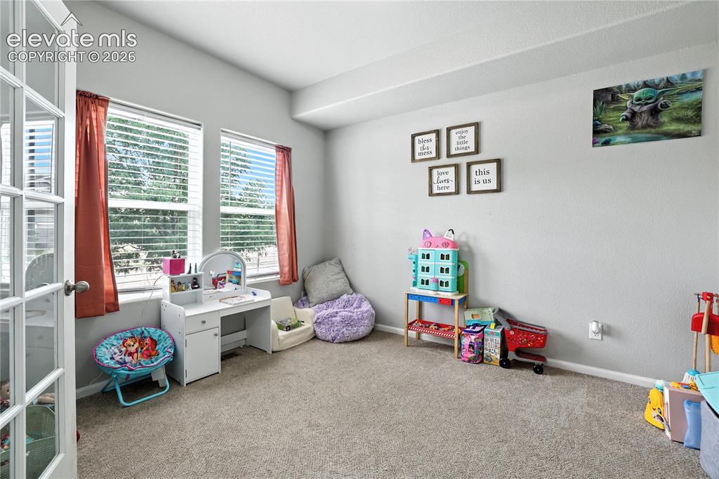 Image 14 of 42: Recessed lighting, light gray wall finish, neutral tone carpet flooring, an