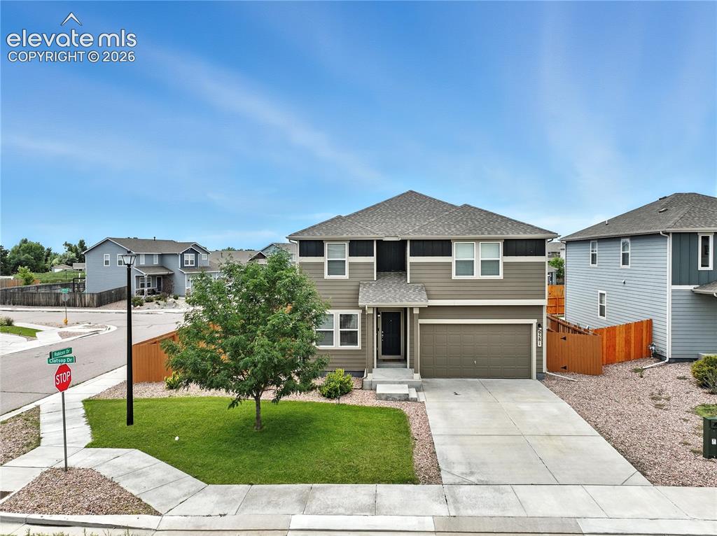 Image 2 of 42: Two-story residence featuring composite siding, an attached two-car garage,