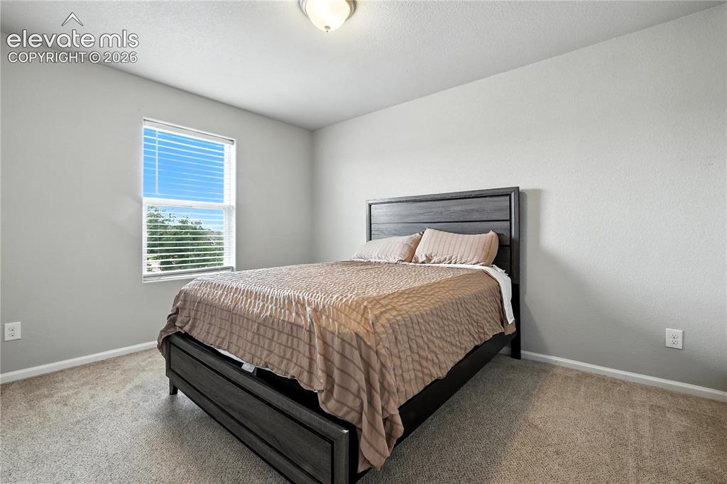 Image 27 of 42: Neutral wall color, window with blinds, and carpeted flooring
