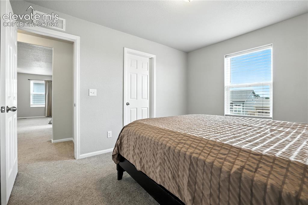 Image 28 of 42: Neutral gray wall paint, white trim, carpet flooring, window with blinds, a