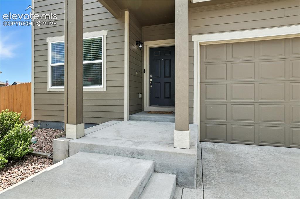 Image 3 of 42: Horizontal siding exterior with a paneled garage door