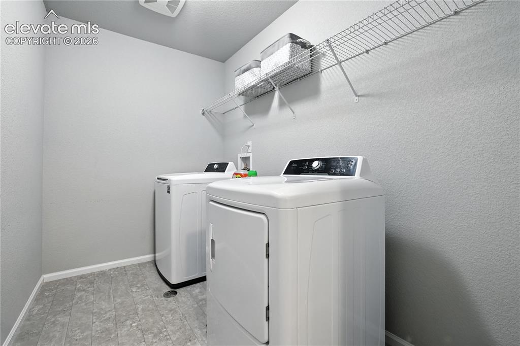 Image 32 of 42: Utility room featuring a wire shelving unit and textured walls