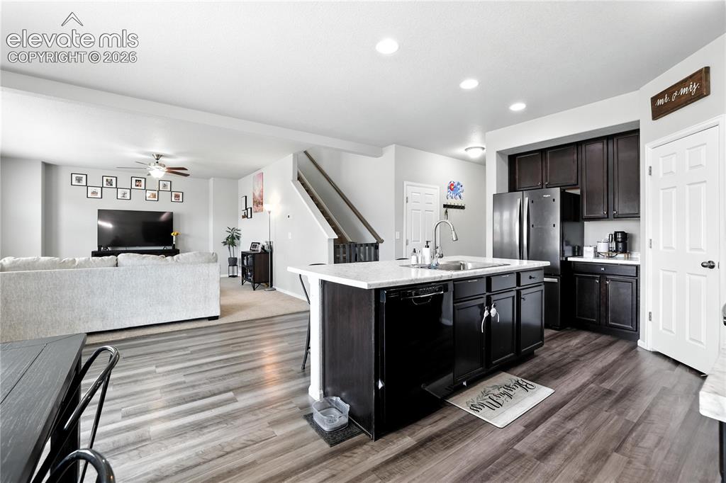 Image 8 of 42: Open-concept layout featuring wood-finish flooring, recessed lighting, dark