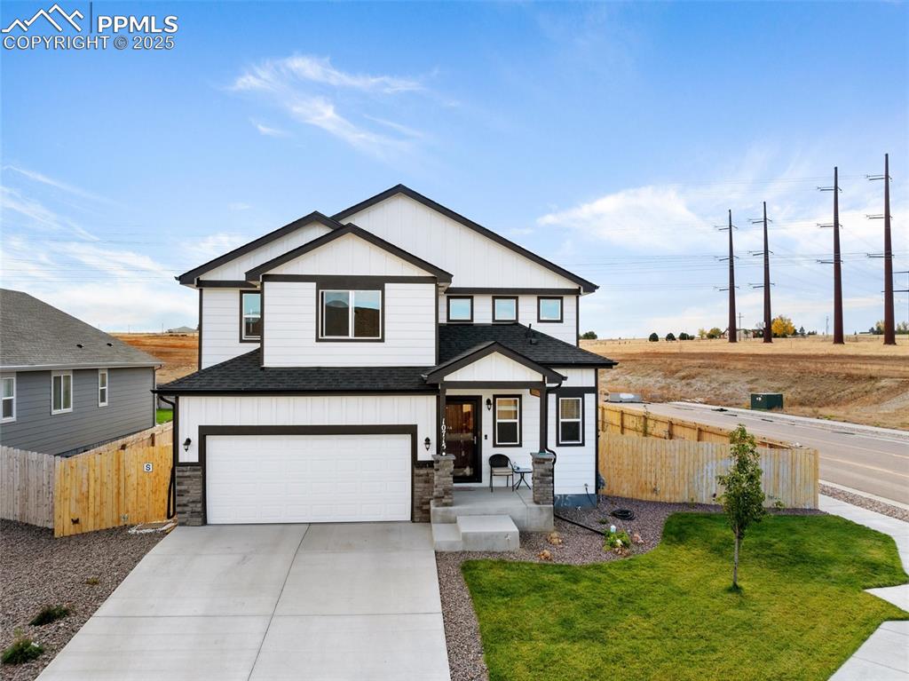 Caption: Front view of 4 bedroom, 4 bath home with 2-car garage on a corner lot.
