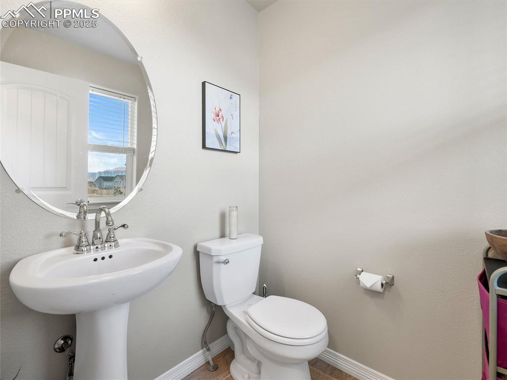 Image 10 of 32: Main Level Powder Bathroom with pedestal sink.
