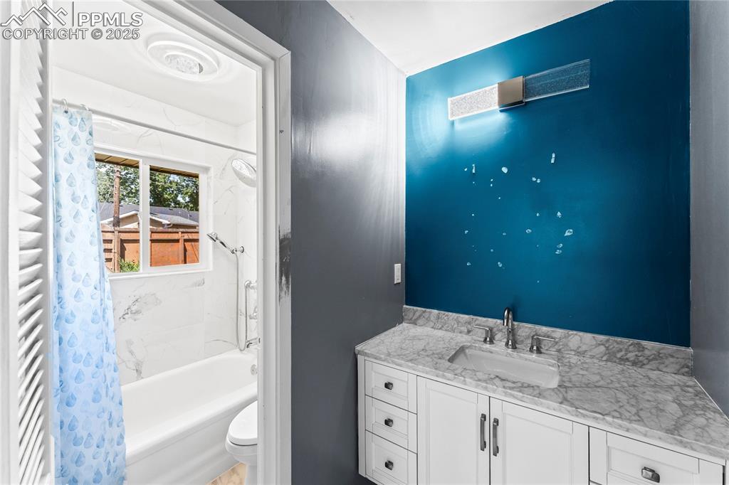 Image 12 of 27: Full bath featuring shower / tub combo with curtain and vanity