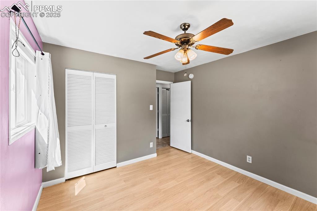 Image 15 of 27: Unfurnished bedroom featuring light wood finished floors, a ceiling fan, an