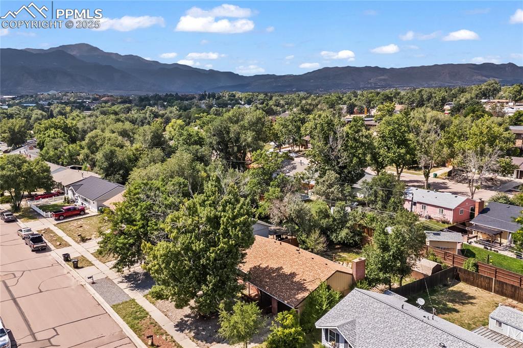 Image 25 of 27: Aerial perspective of suburban area featuring mountains