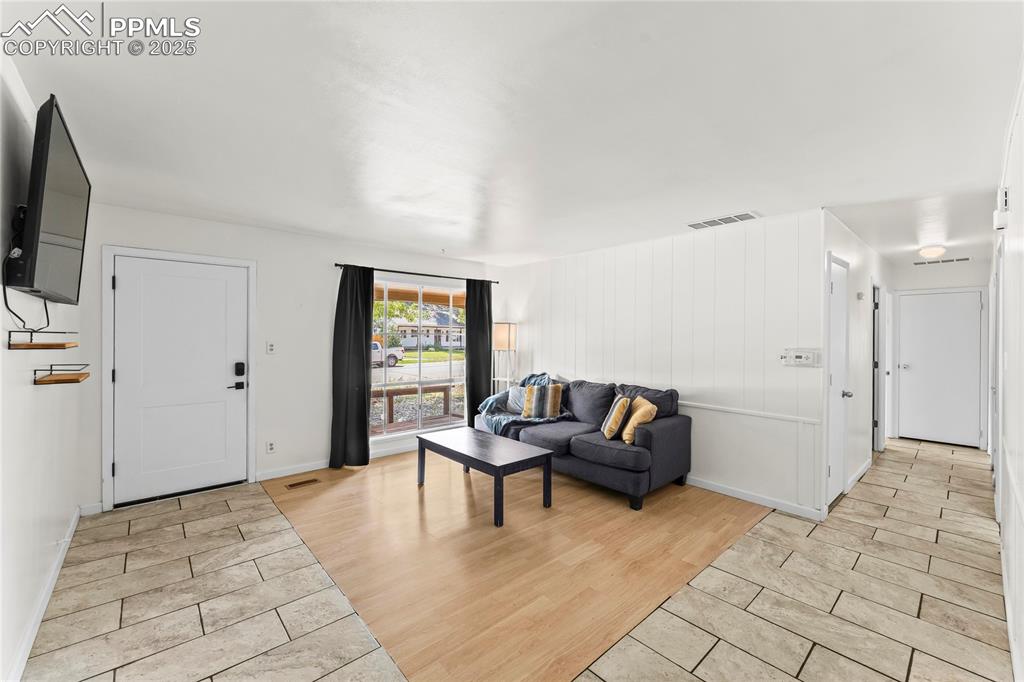 Image 4 of 27: Living room with light wood finished floors