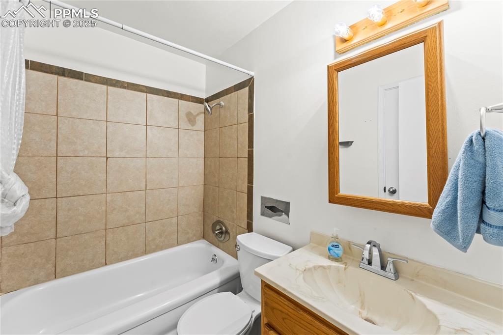 Image 7 of 27: Bathroom featuring shower / bath combo and vanity