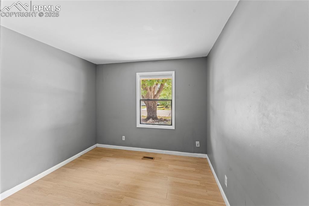 Image 8 of 27: Spare room featuring baseboards and light wood-type flooring