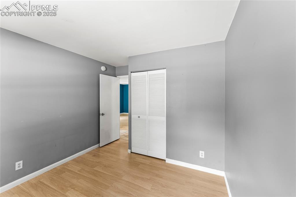 Image 9 of 27: Unfurnished bedroom featuring light wood-style flooring and a closet