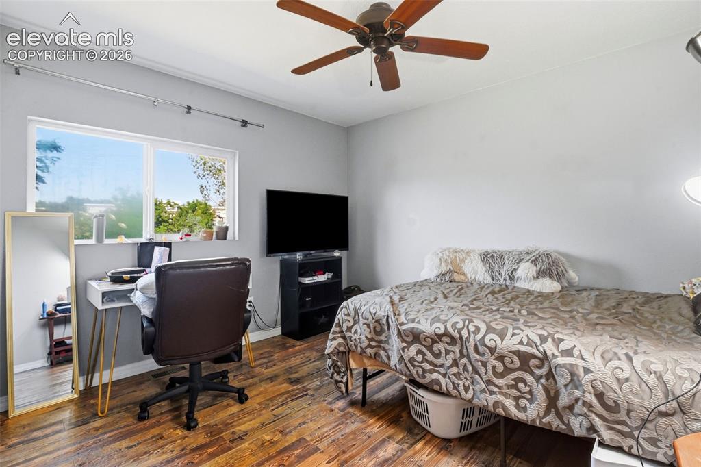 Image 23 of 34: Wood-finish flooring, a ceiling fan, and window