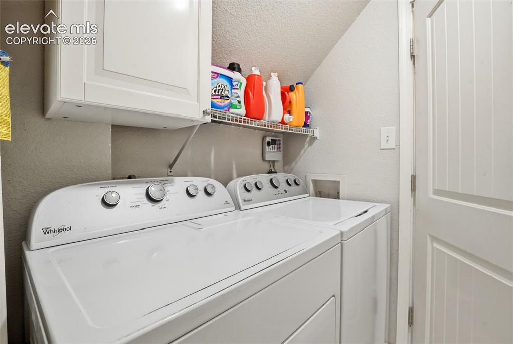 Image 25 of 34: Built-in upper cabinetry, wire shelving, and a paneled door