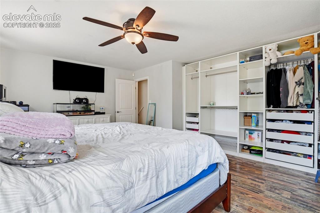 Image 29 of 34: Wood-finish flooring, built-in open shelving, built-in drawers, and a ceili