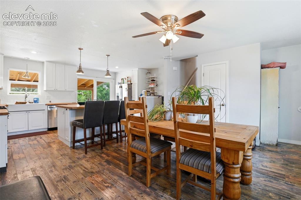 Image 6 of 34: Kitchen featuring white cabinetry, a farmhouse sink, stainless steel applia