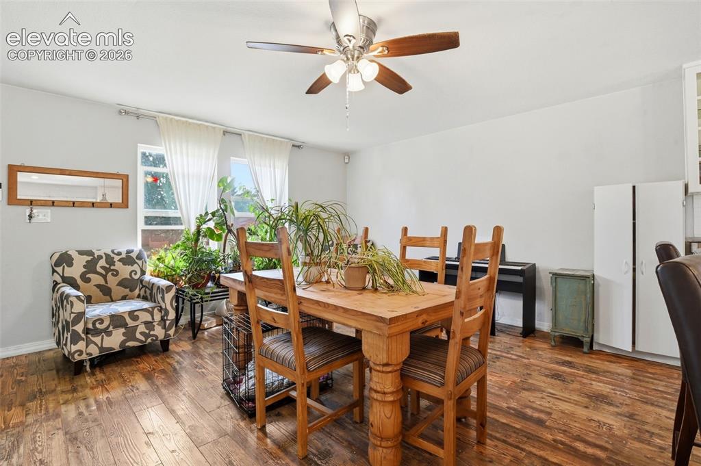 Image 8 of 34: Hardwood-finish flooring, ceiling fan with light fixture, and white painted
