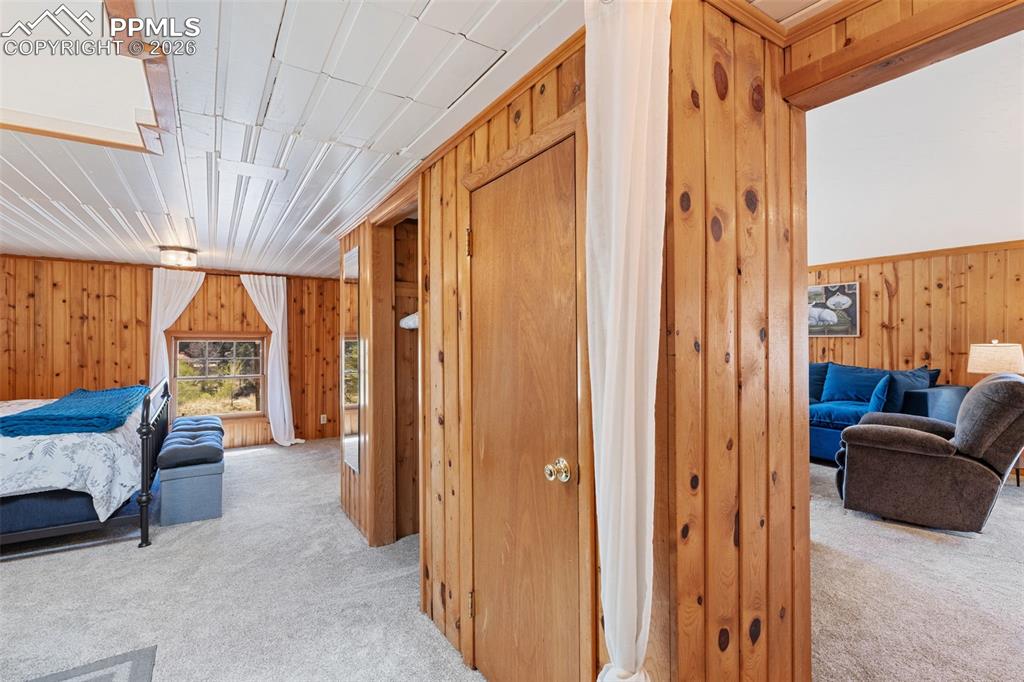 Image 18 of 35: upper level primary bedroom on left/ living room to right