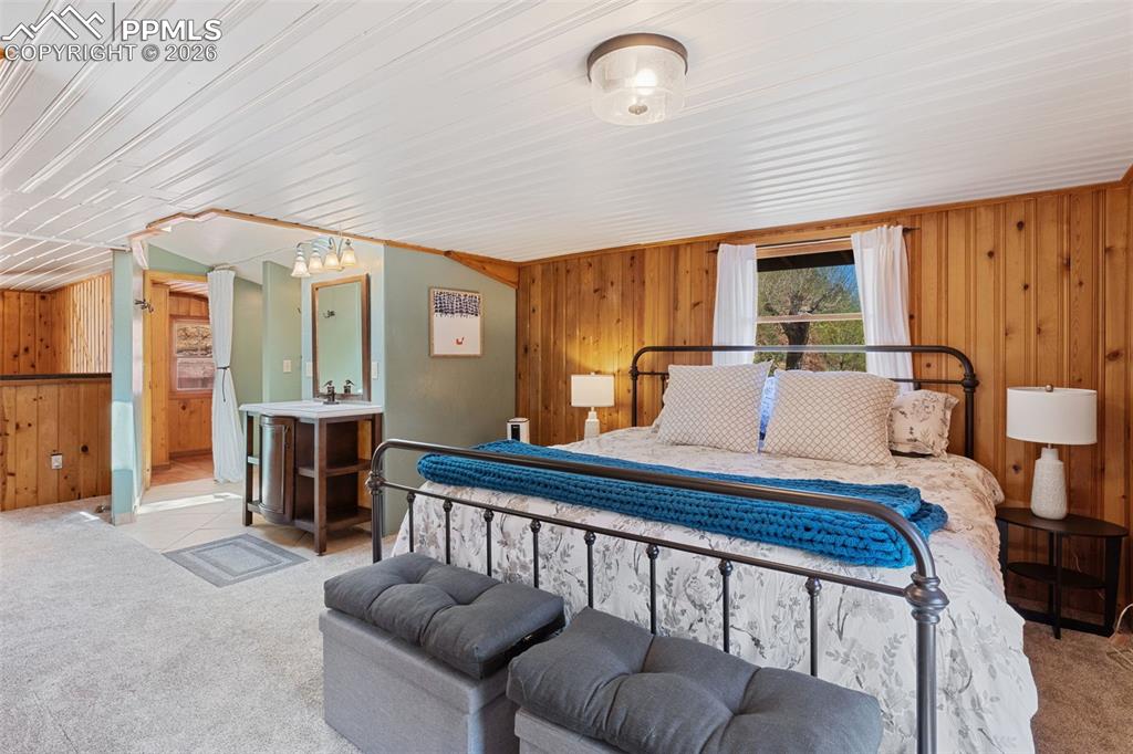 Image 20 of 35: upper level primary bedroom with adjoining bathroom 