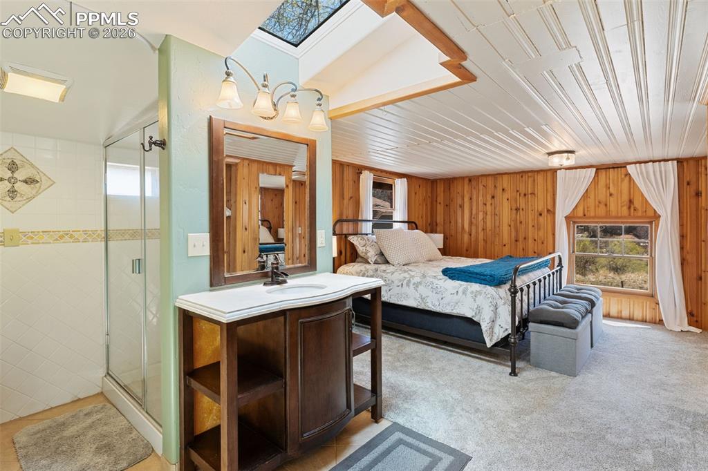 Image 21 of 35: upper level with skylight and adjoining bathroom