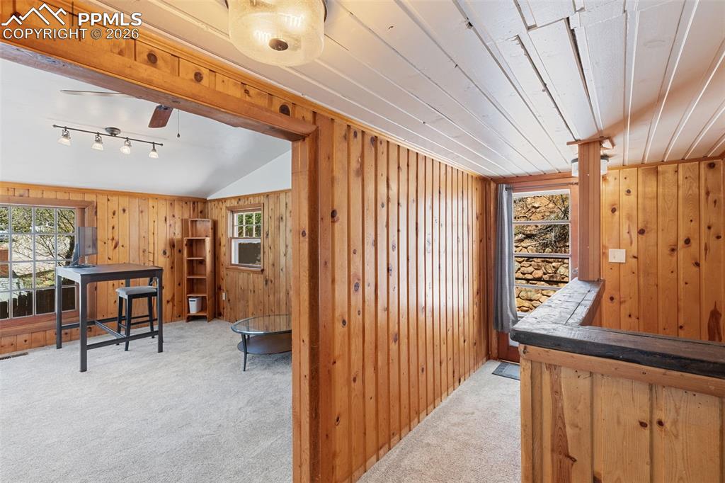 Image 23 of 35: upper level living room to left and back patio entrance 