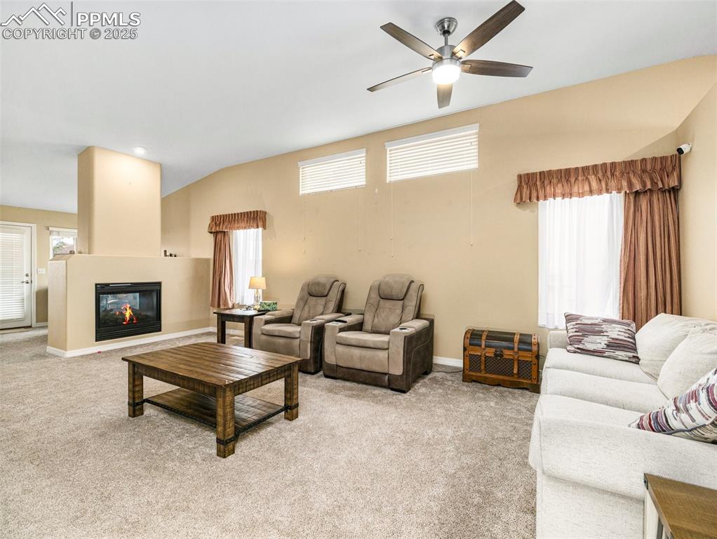 Image 6 of 17: This large, open living room with a double sided gas fireplace to enjoy on