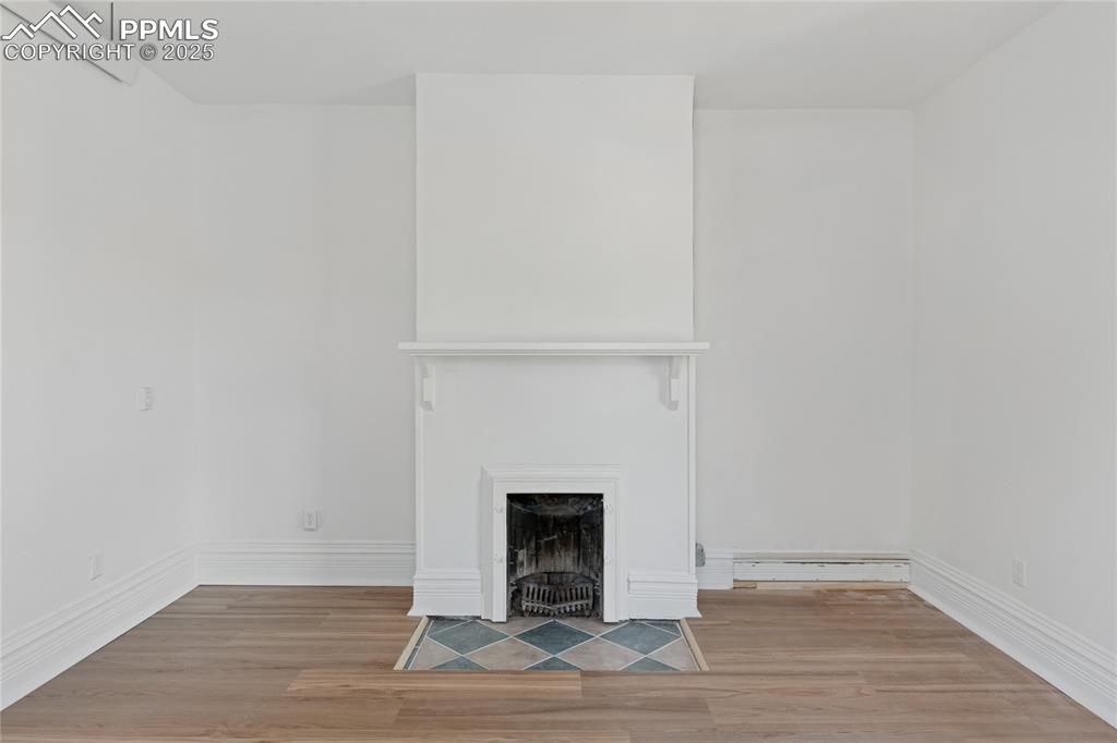 Image 11 of 45: Main-level flat primary suite features a fireplace