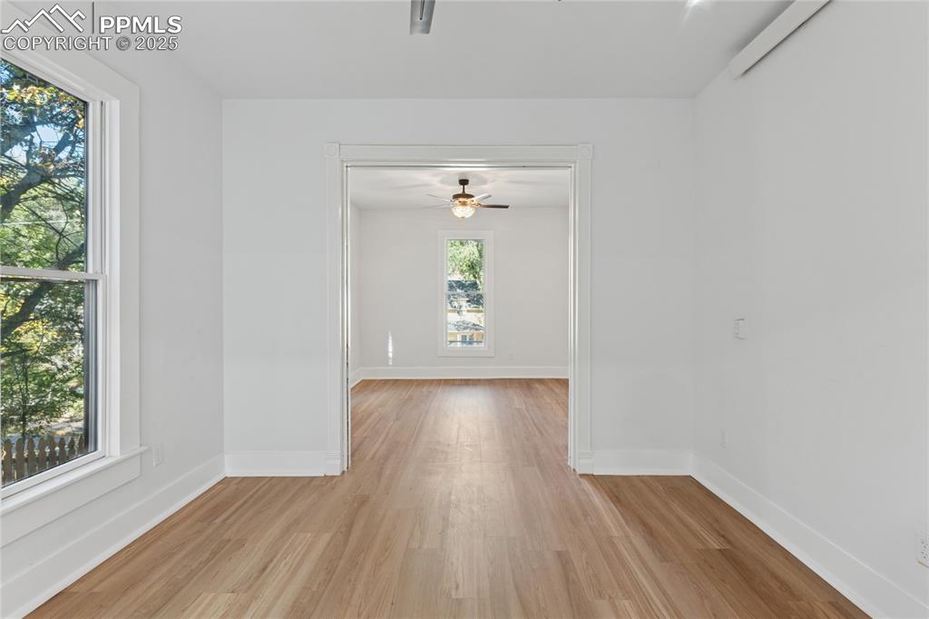 Image 12 of 45: Main-level flat living area + 2nd bedroom separated by sliding doors