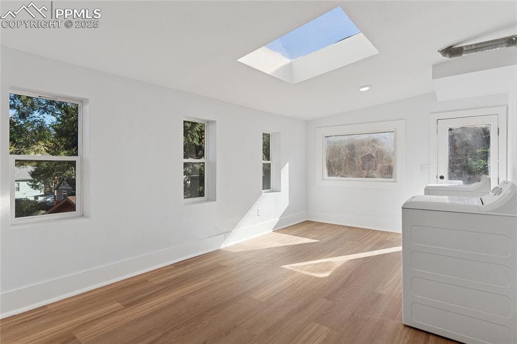 Image 33 of 45: 2nd-floor flat sunroom, laundry, door to backyard
