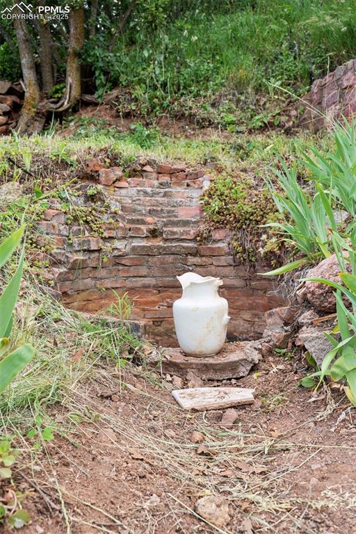 Image 37 of 45: Whispers of the original well remain in the backyard