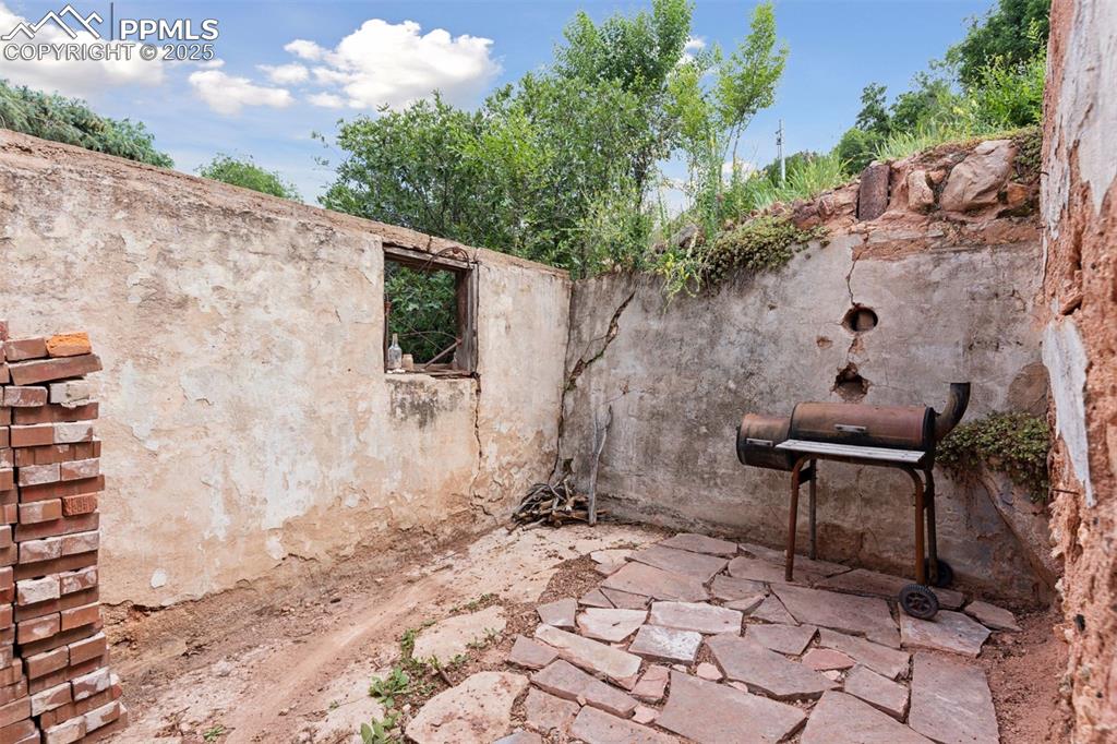 Image 38 of 45: Original outdoor kitchen provides historical touch