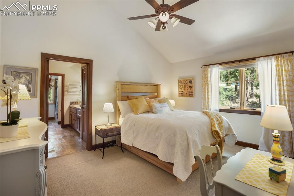 Image 24 of 50: Upper level guest bedroom with en suite full bath