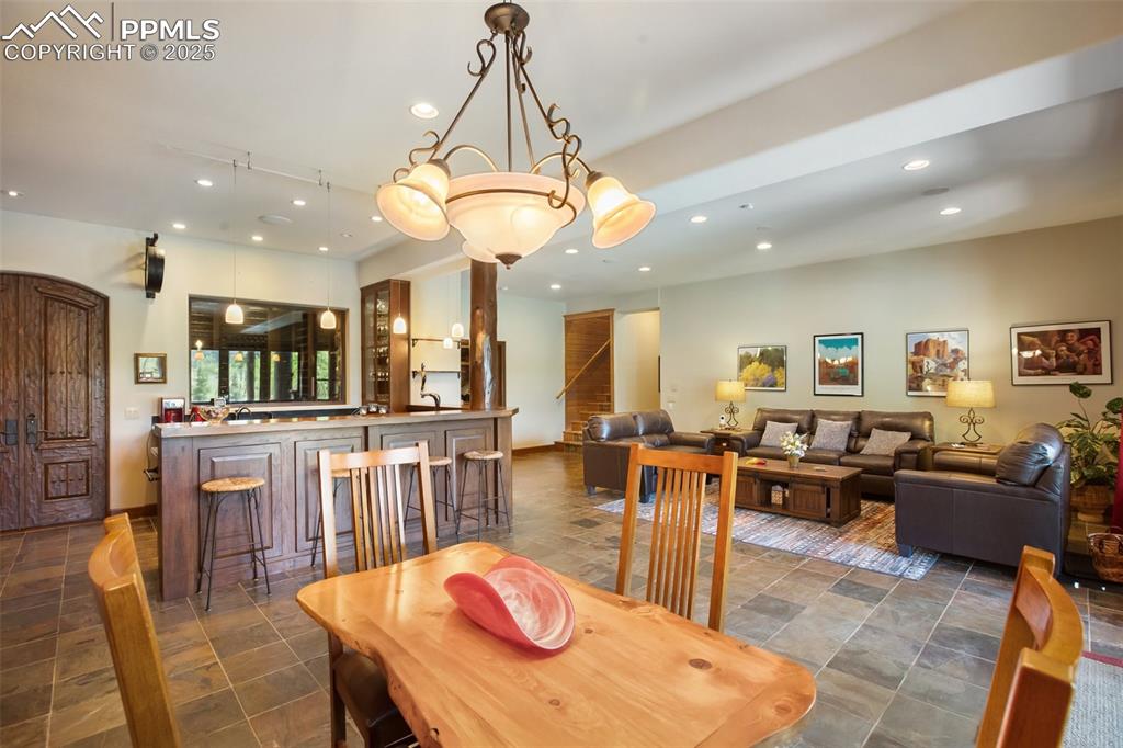 Image 37 of 50: Game area and dining seating in the family room