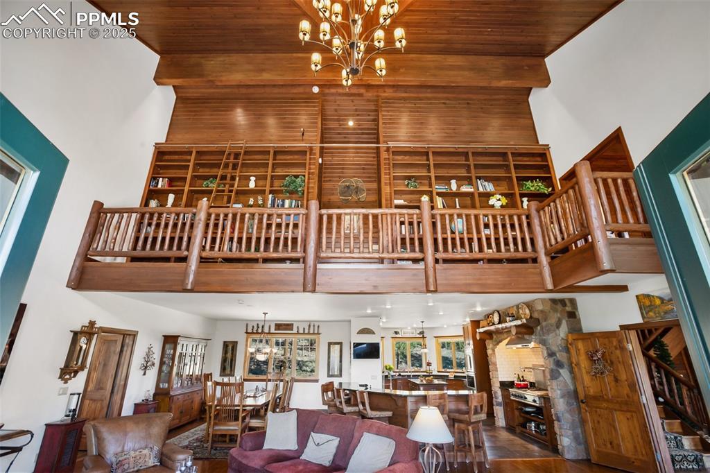 Image 8 of 50: Library overlooking the living area, with the rolling library ladder