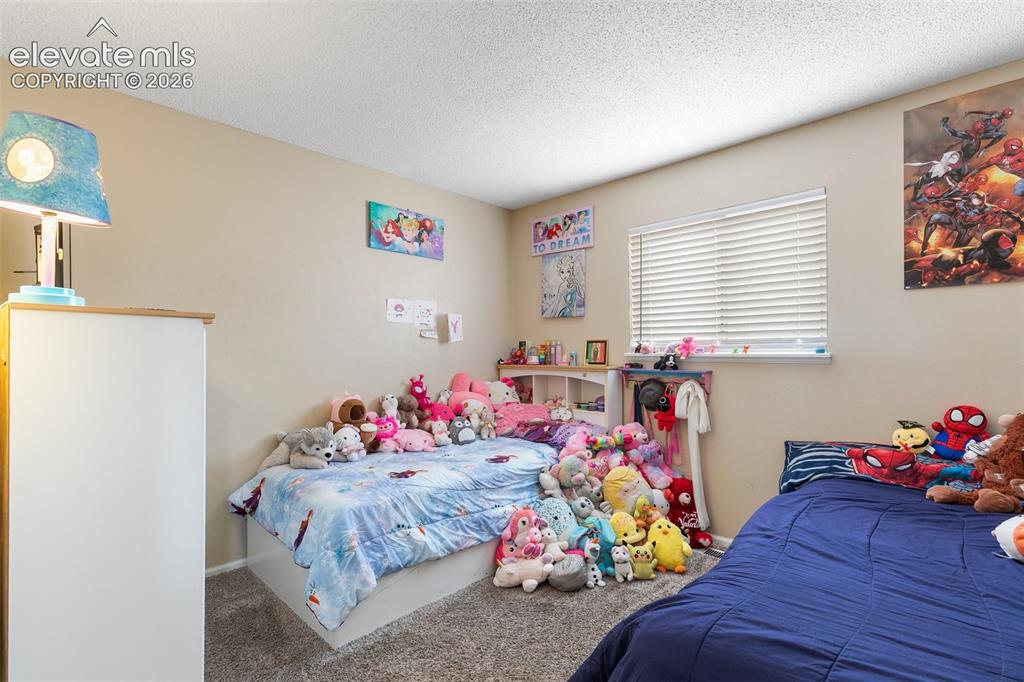 Image 15 of 29: Carpeted room featuring neutral wall paint, a window with horizontal blinds