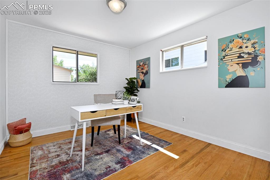 Image 15 of 35: Down the hall, this sunny second bedroom could be used as a home office!