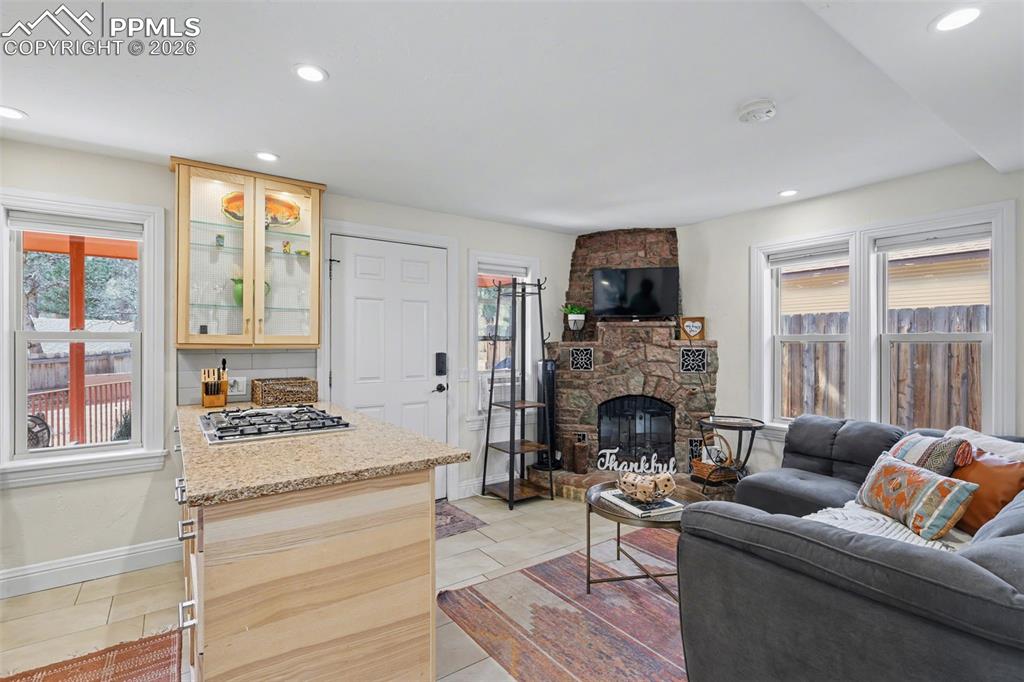 Image 5 of 29: The living room features an electric fireplace to cozy up next to and windo