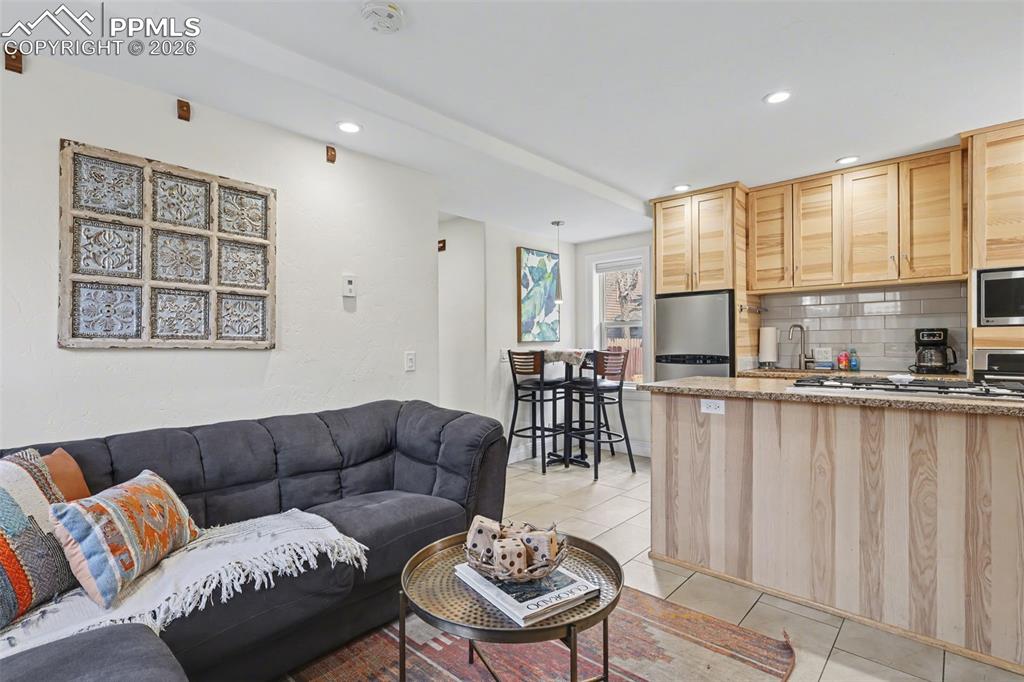 Image 7 of 29: Off the living room area is the kitchen for all of your cooking and baking