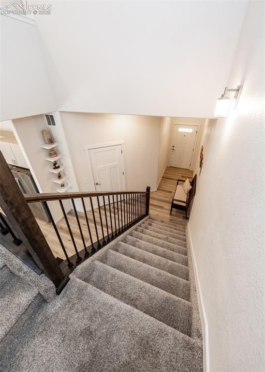 Image 24 of 49: Staircase featuring carpet floors and baseboards