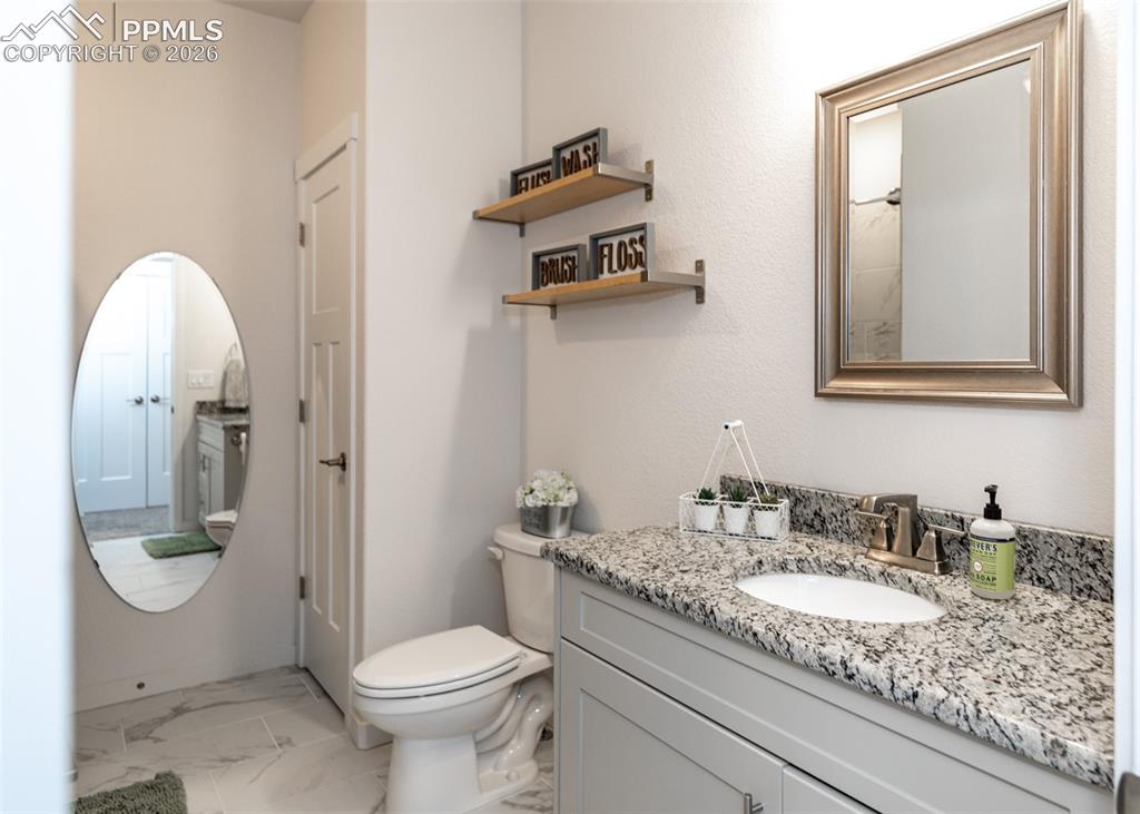 Image 37 of 49: Bathroom with vanity and light marble finish floors