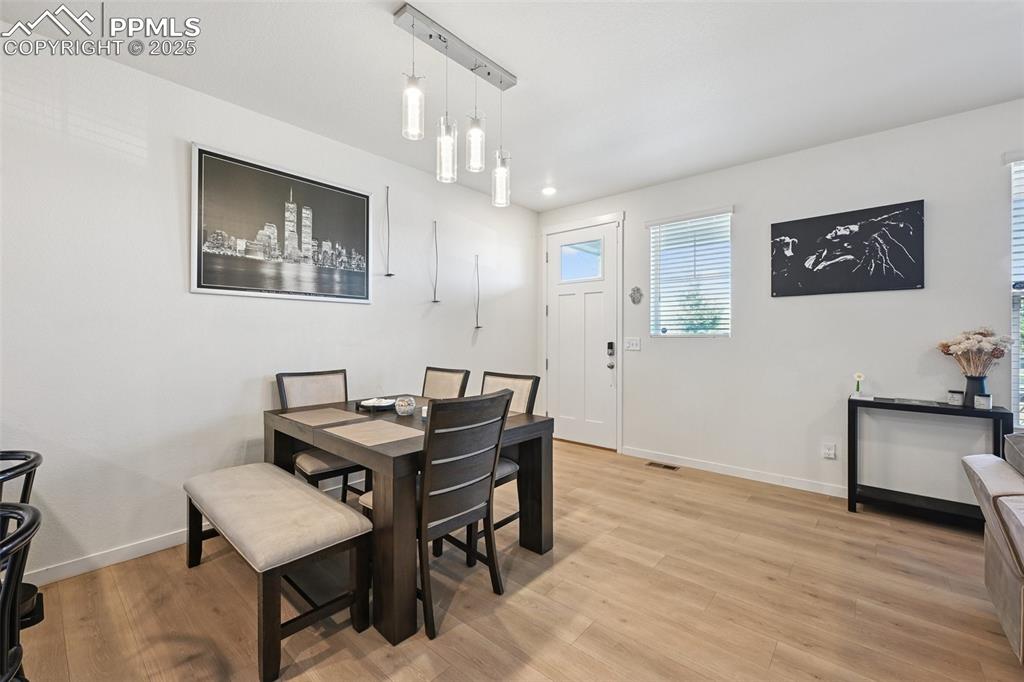 Image 18 of 35: Dining area featuring baseboards and light wood-style floors