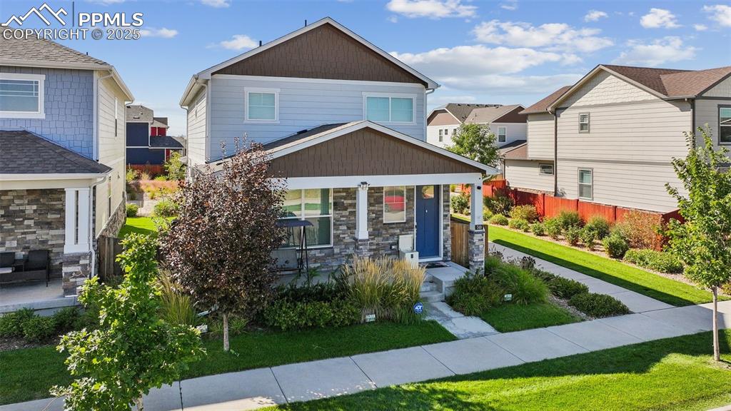 Image 3 of 35: Craftsman-style house featuring a residential view and stone siding